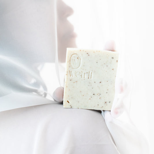 Classic campaign - rice and black pepper soap square held up by a hand