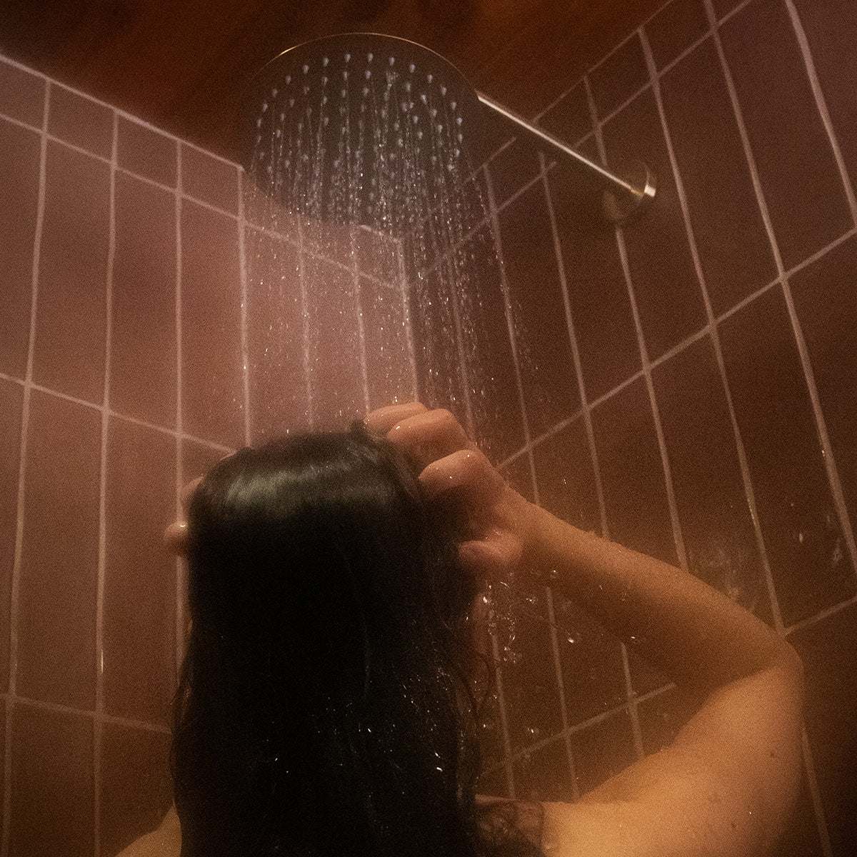 A woman taking sometime in her Weirli shower experience