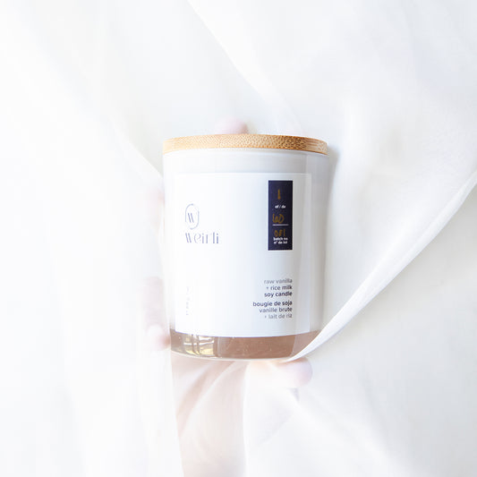 Raw Vanilla and Rice Milk Soy Candle on a white fabric background